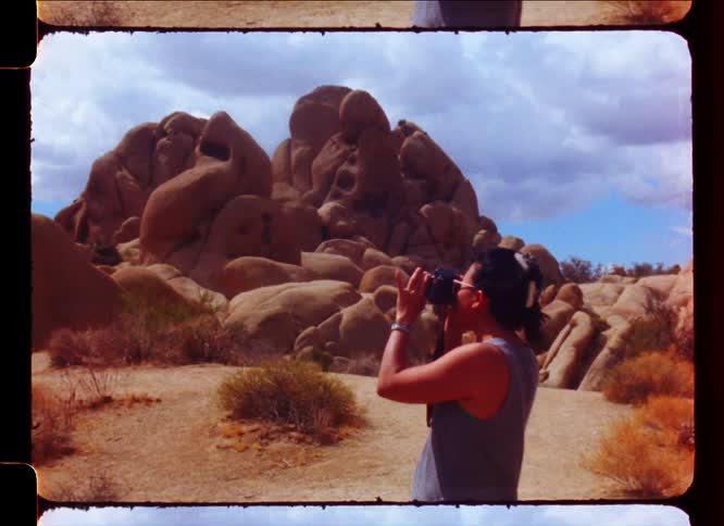 Woman using a professional camera and photographing rocks