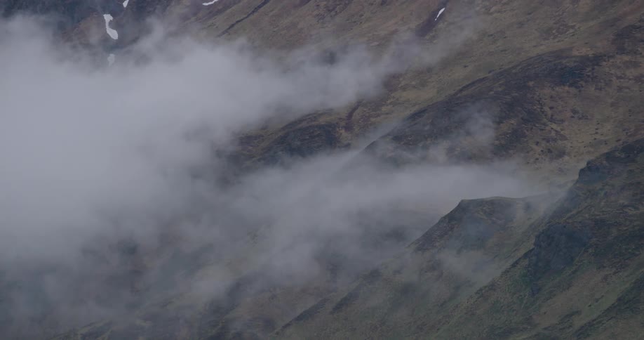 Mountain wall with moss snow and fog