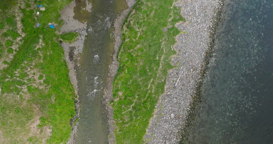 Aerial view of a dam with a river flowing through