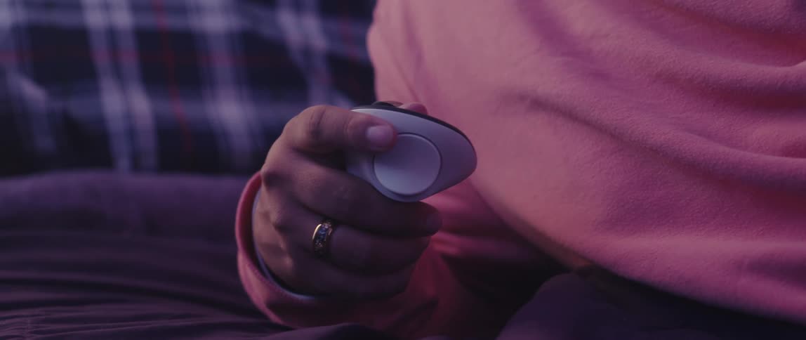 A person is pressing the buttons on the controller