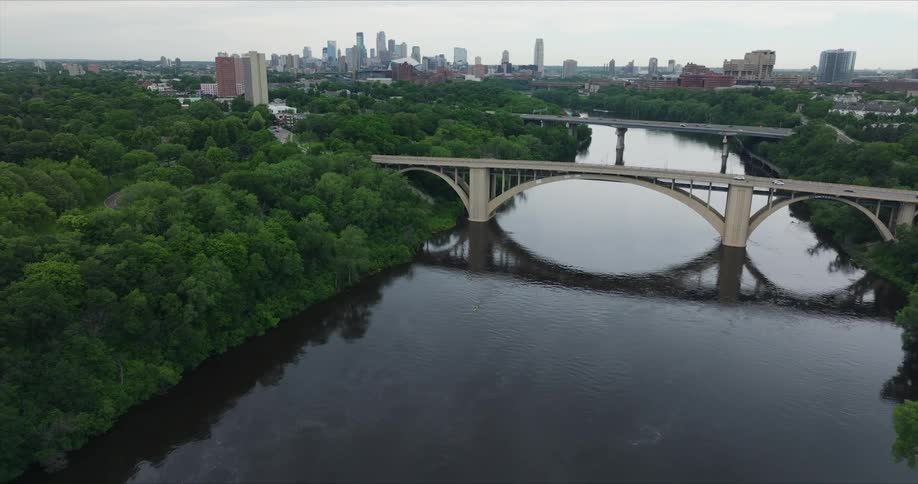 Aerial view of a river with bridge crossings and a metropolis in the background