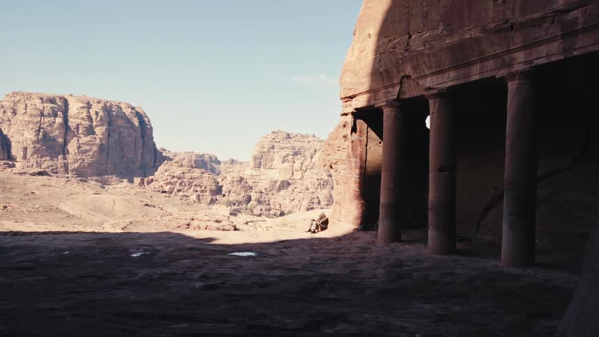 Ruins with classical columns and canyons in the background