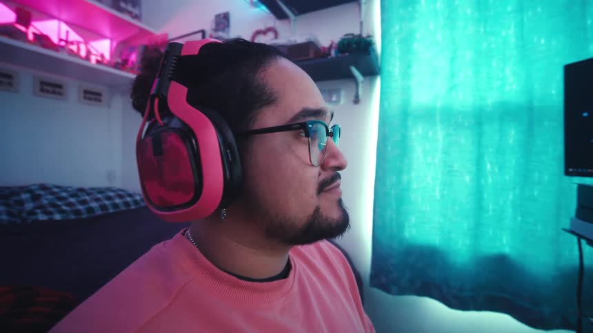 Man having fun playing video games in a setup in his bedroom