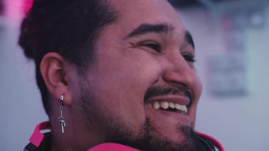 Side portrait of a man in an indoor space smiling