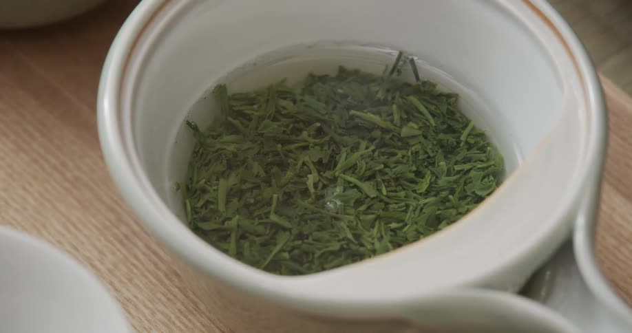 Pouring hot water over herbs to make a tea