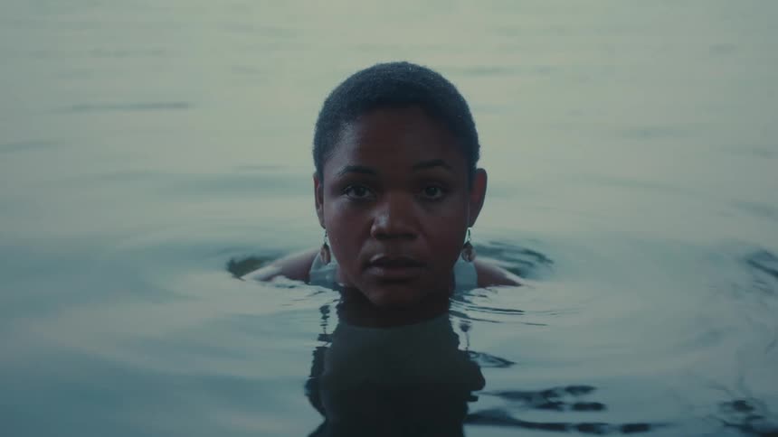 Person calmly emerging from the water in a serene environment
