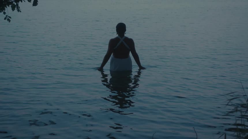 Woman in white dress in the river