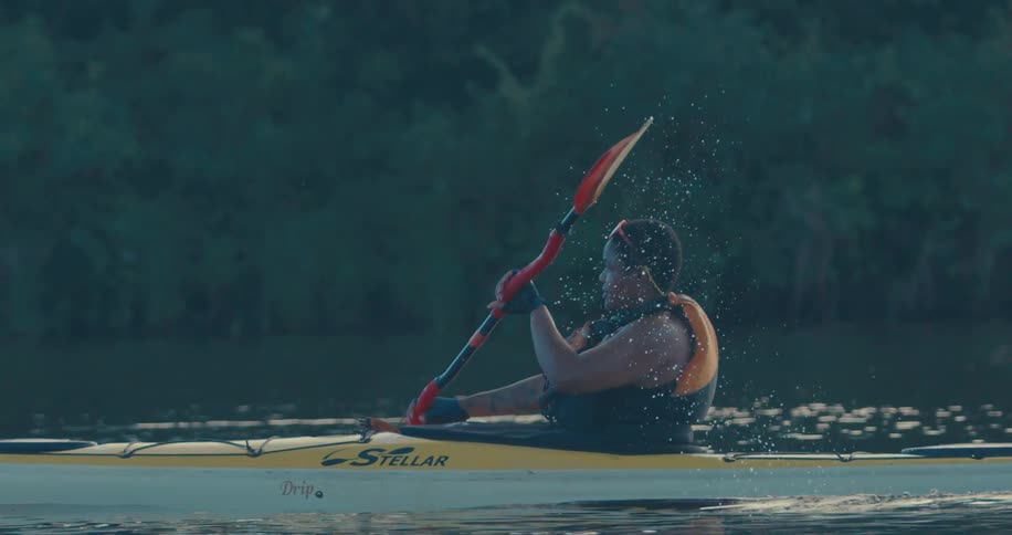 A woman is rowing a kayak