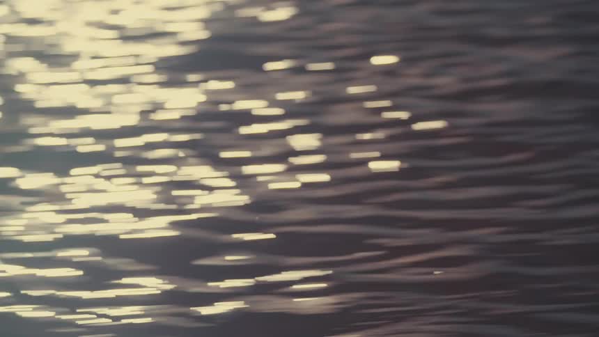 Moving view of the suns reflection on ocean water