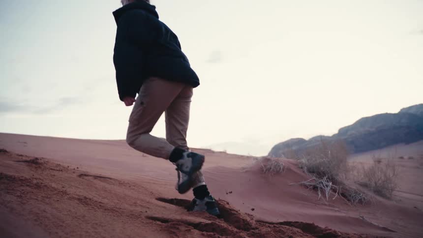 Woman climbing a desert area
