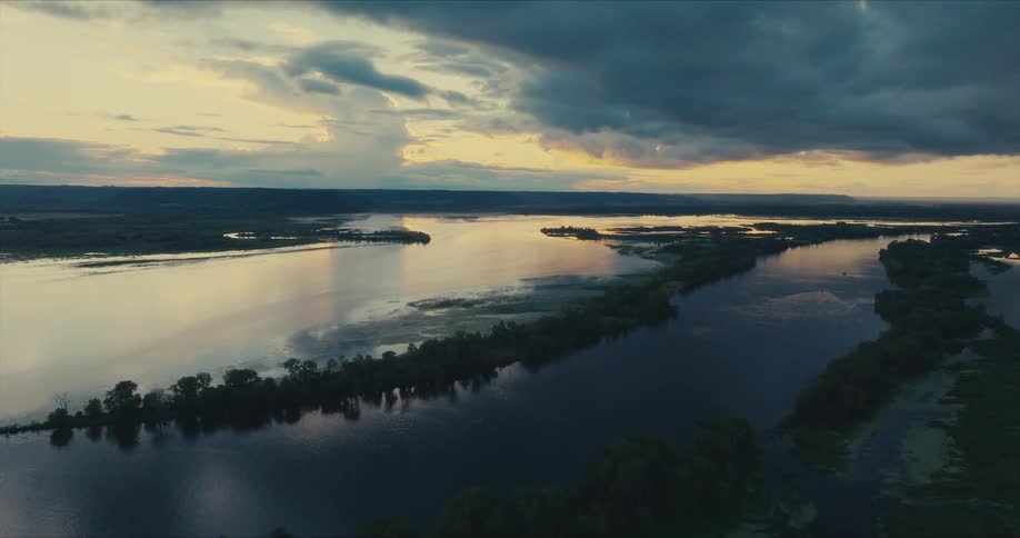 Heavy clouds are over the river at sunrise