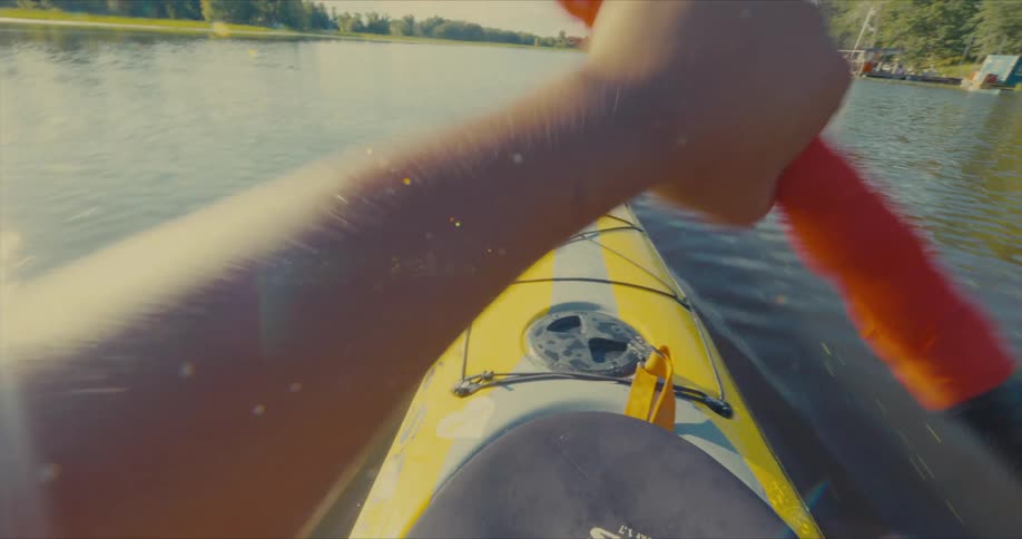 A person is kayaking on a sunny day