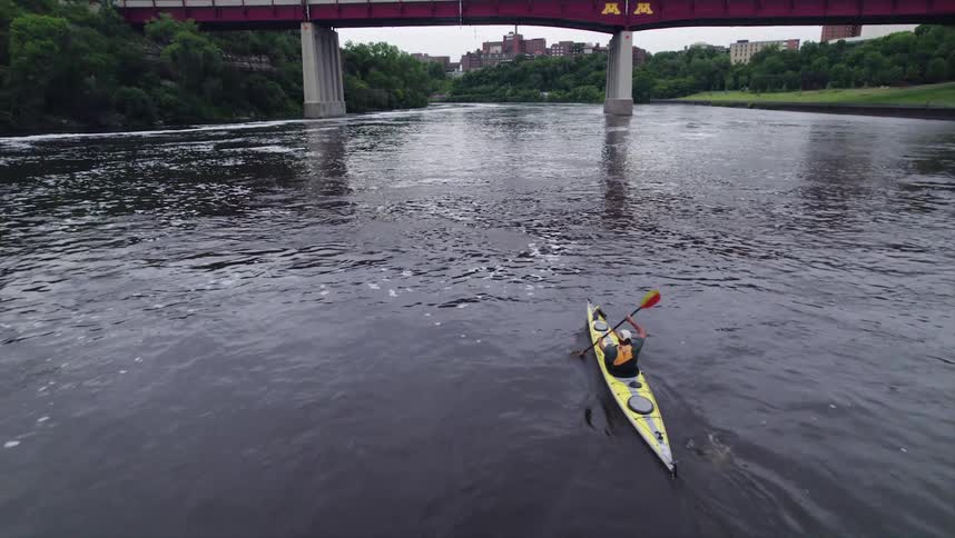Top view of a person canoeing on a river