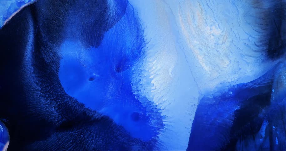 Extreme close up of an abstract liquid in blue and white colors