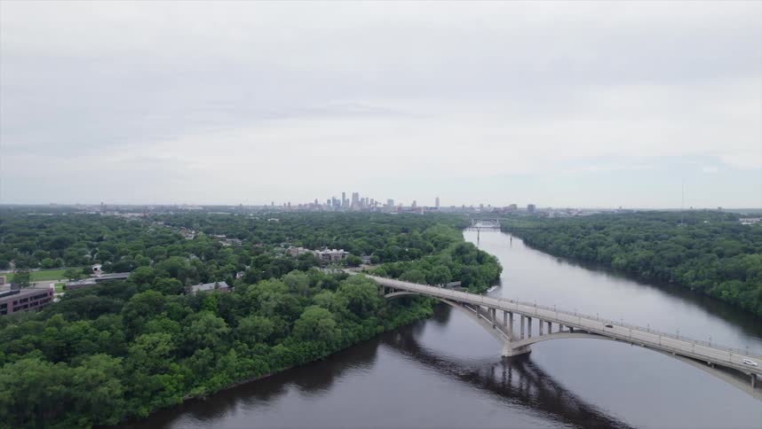 Aerial view of a bridge over the river and a city in the background