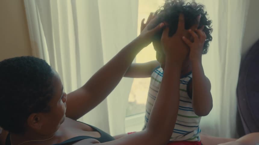 A mother is playing around with her son