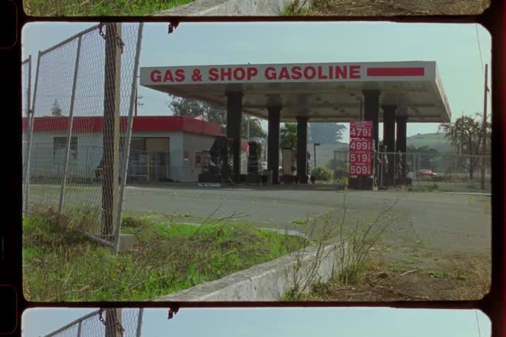 Gas station and in the background a highway with vehicle traffic