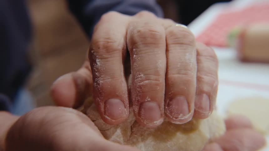 Closeup of a man kneading sugar cookie dough