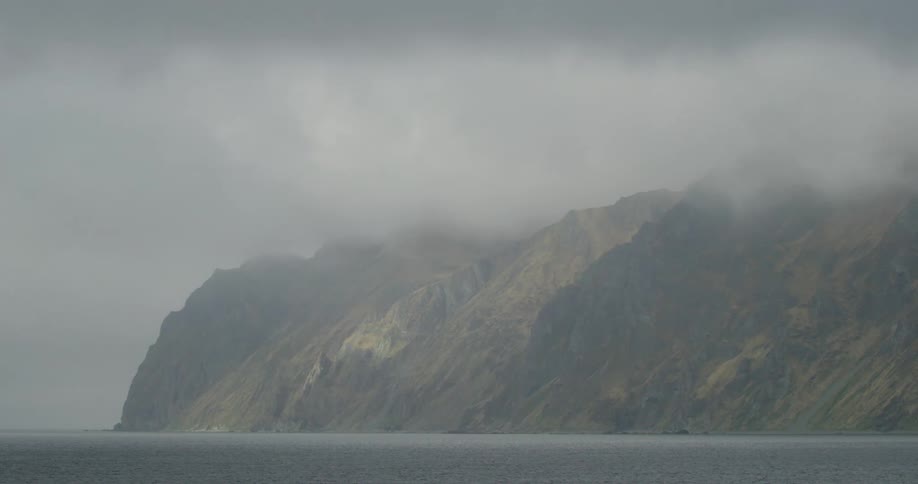 Heavy fog is on the mountains by the shore