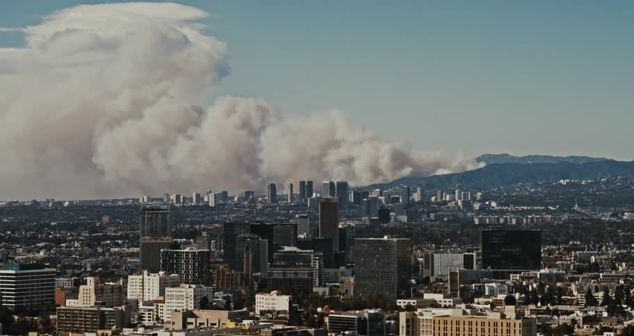 A giant cloud of smoke rises over West Los Angeles as the Palisades fire burns