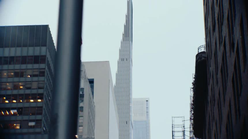 An american flag is on top of the skyscraper
