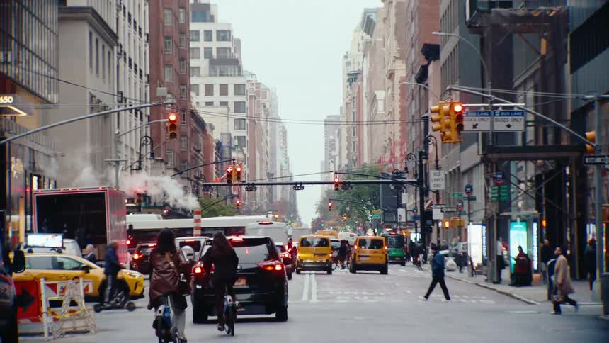 A bustling street scene with tall buildings and pedestrians on a busy sidewalk