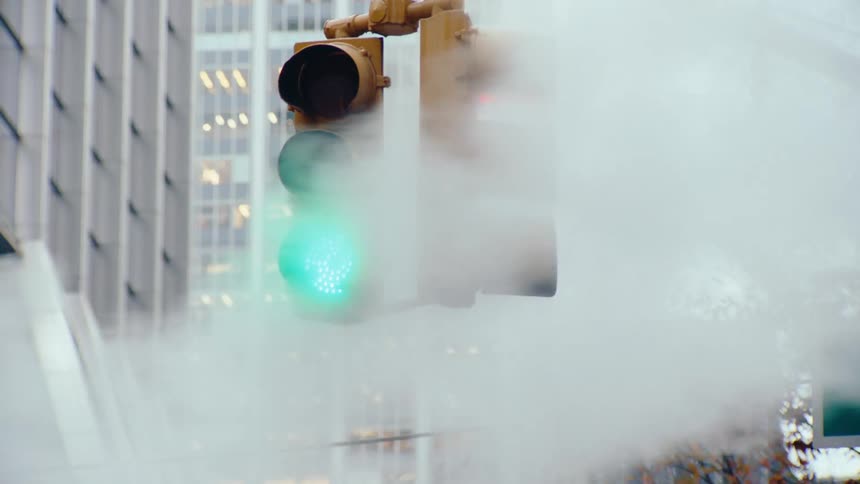 Traffic light in an urban village with green signal