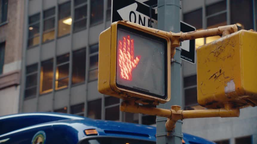 Close up of a pedestrian stop sign allowing passage