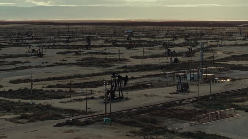 Panorama on a cloudy day of oil machinery operating in a desert area