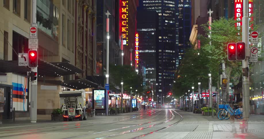 Urban road of a metropolis at night with traffic of vehicles trains and pedestrians