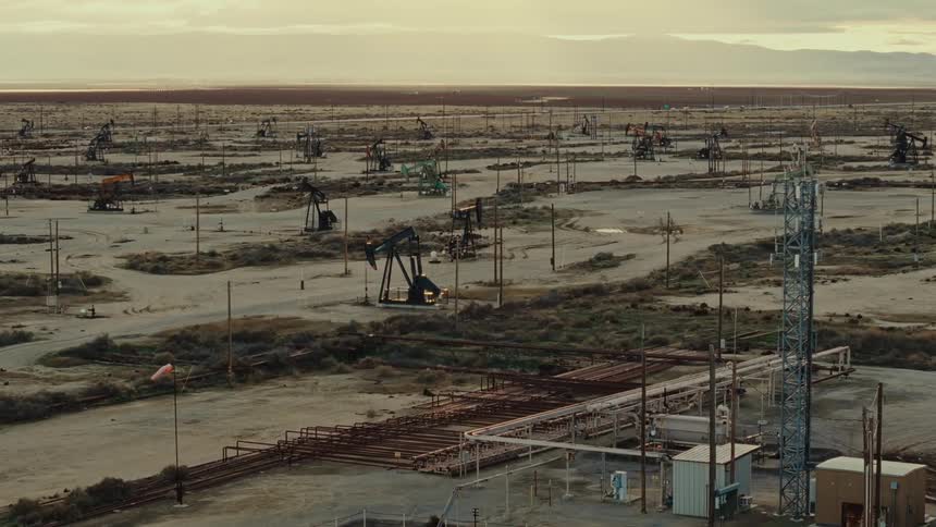 Aerial view of oil machinery in action in a natural desert area