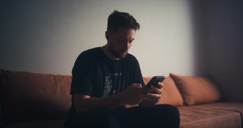 A clip of a person operating a smartphone indoor