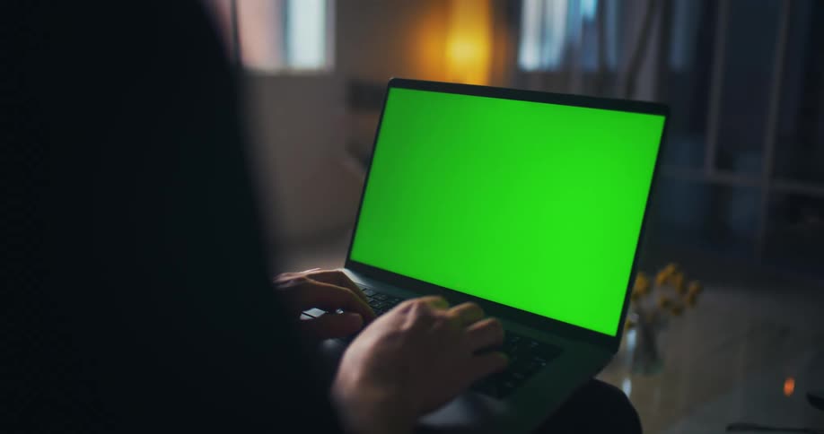 Hands typing on a laptop