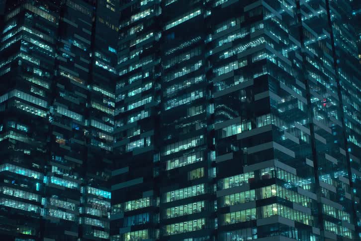 Lights of an urban building turning on at night