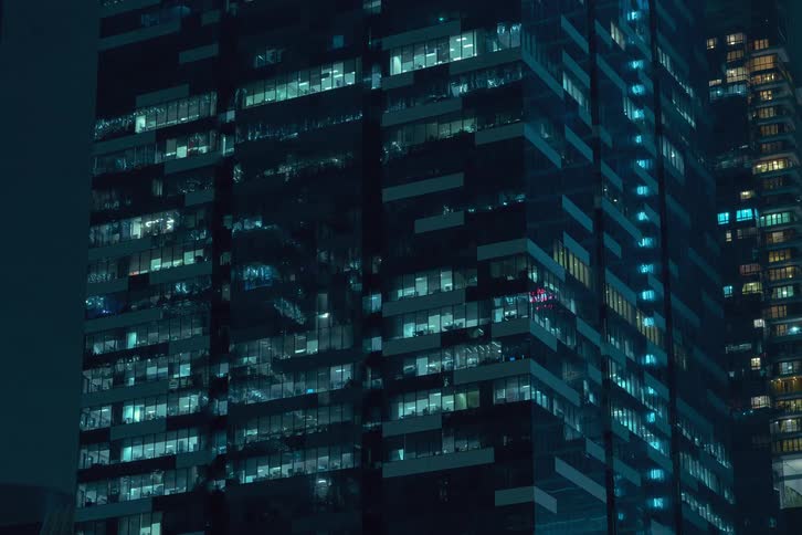 Lights on different floors of the office building flash before turning off