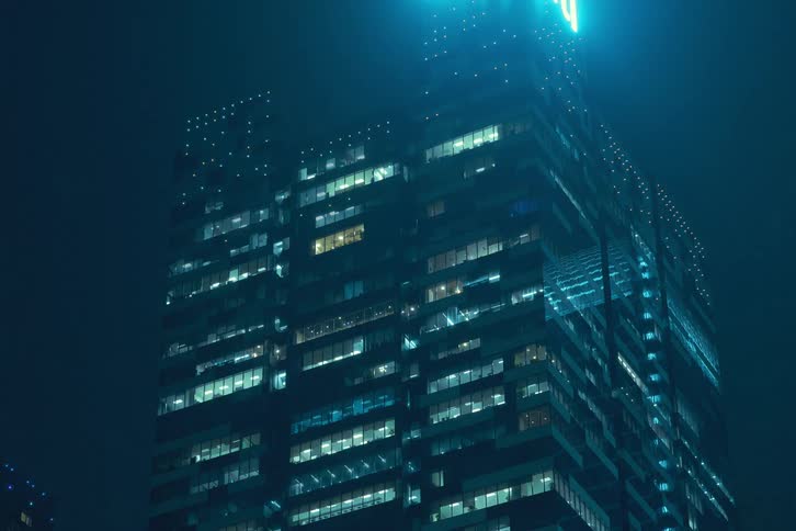 Urban building with lights flashing and pulsing at night