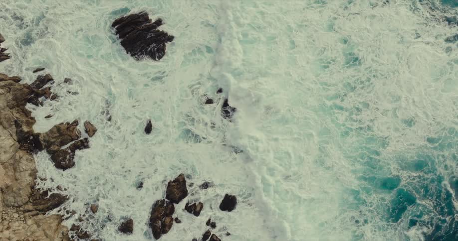 Waves crash on the rocks of the shore