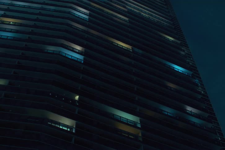 The lights flash in the many windows of the building