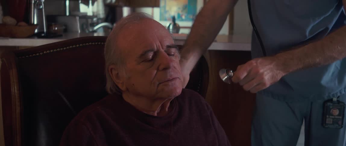 A doctor is listening to a mans heartbeat with a stethoscope