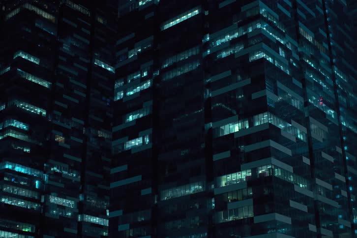 Many lights of city buildings going out and off at night