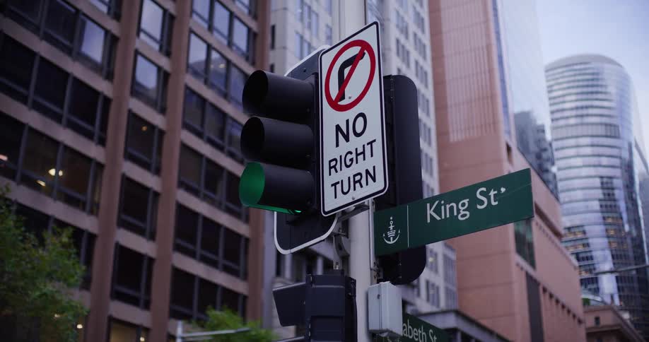 A traffic light is on the corner in the city