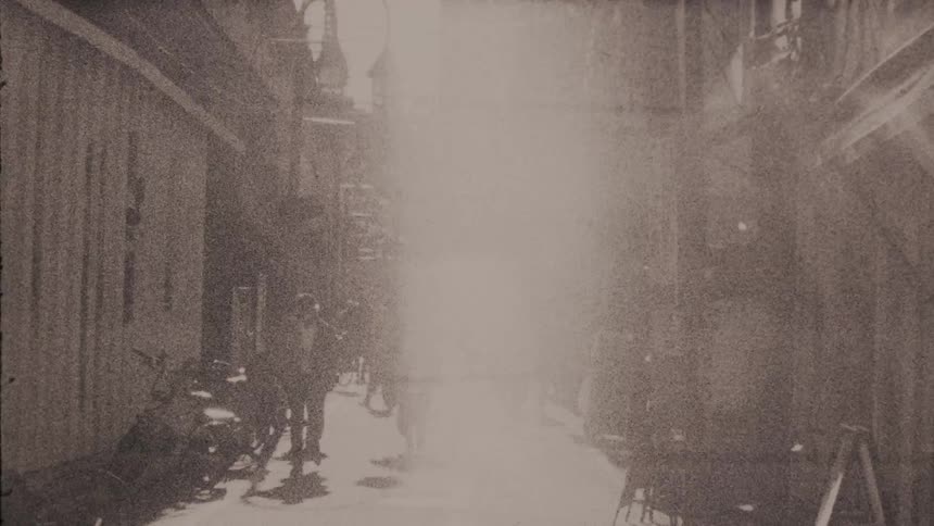 Pedestrians walking in an alley during the day