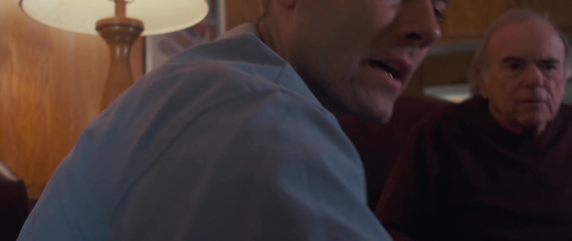 A doctor is discussing something with a patient at home