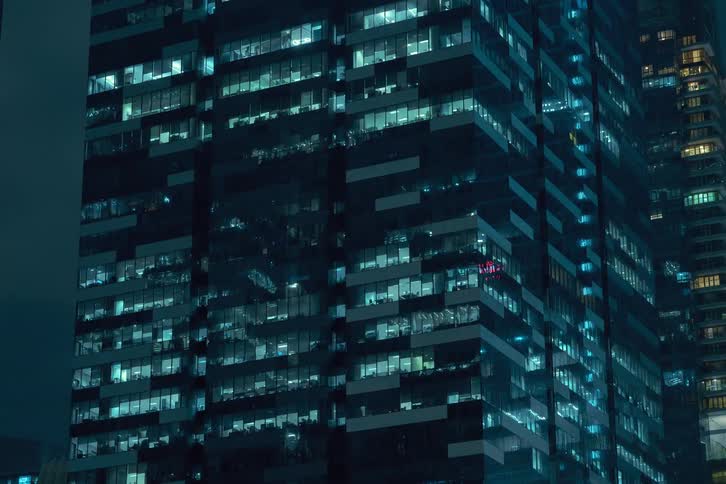 Lights flicker on all floors of the buildings