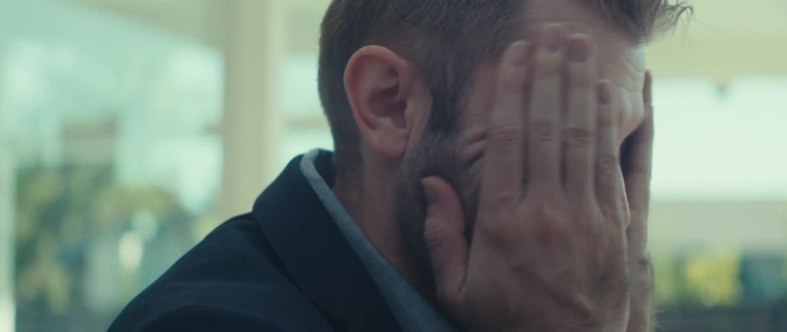 Man sitting down unhappy putting his hand on his face