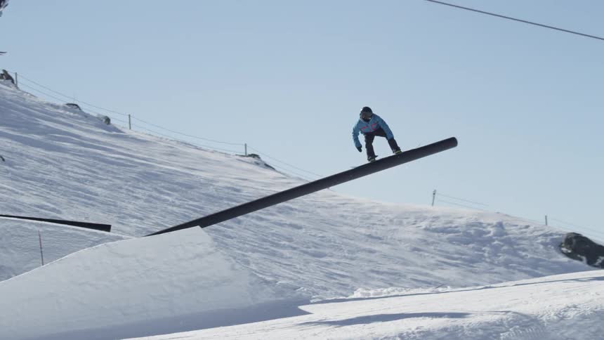 Person skiing down a slope to make a jump on a sunny day