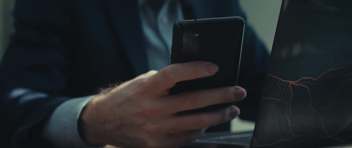 Man sitting and interacting with his smartphone