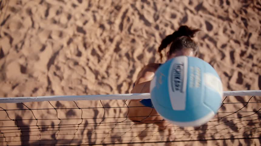 A woman is playing volleyball
