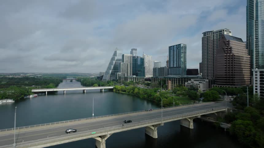 Aerial view of a cityscape with a bridge spanning over a river