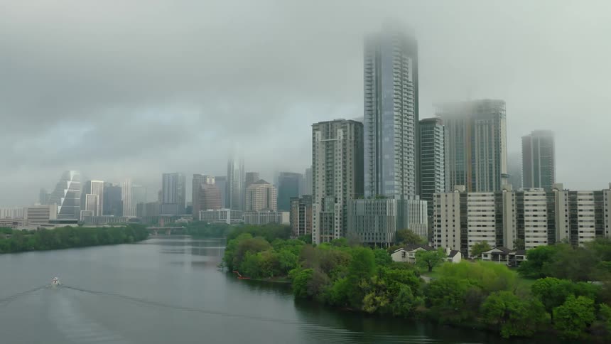 Aerial panorama of a metropolis with modern skyscrapers on the seashore on a foggy day